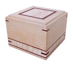 a small wooden box with red trimmings on the top and bottom, sitting in front of a white background