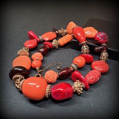 Vintage orange red mix beaded necklace,  24'' long red necklace, Chunky beaded necklace Metal -  gold-tone metal Stone - orange and red mix beads, red coral, glass, porcelain, cinnabar beads 24'' long red necklace, Chunky beaded necklace  Size - 24'' Mark -  Circa the 1960s - 1980s Condition - good condition. PLEASE NOTE: Vintage jewelry can show signs of wear and discoloration or chipped metal consistent with age. Please look at the pictures carefully. Most were purchased at estate sales, aucti Orange Red Coral Beads For Jewelry Making, Vintage Red Gemstone Beads, Orange Red Coral Gemstone Beaded Necklaces, Orange Red Coral Gemstone Beaded Necklace, Red Carnelian Single Strand Necklace, Red Coral Necklaces With Round Faceted Beads, Red Coral Necklace With Faceted Beads, Faceted Red Coral Necklace, Orange Red Coral Beaded Necklaces With Large Beads