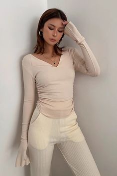 Ribbed V-neck Elastane Top, Stretch Ribbed Knit Top With V-neck, Ribbed V-neck Top In Elastane, Ribbed Elastane V-neck Top, Casual Beige Elastane Tops, Fitted V-neck Knit Top For Loungewear, Beige Stretch Knit Top With V-neck, High Stretch Beige Ribbed Tops, Beige Stretch Tops In Elastane