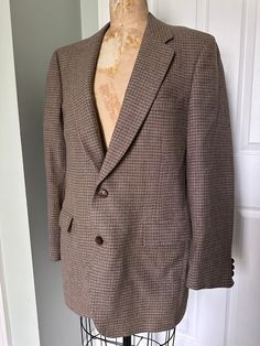 This is a vintage designer lanvin blazer made out of 100% virgin wool in United States, lightweight No stains or holes very good vintage condition No size on it so please refer to multiple photos with the ruler next to it for the exact measurements and details it is 19 to 20 inches from pit to pit Brown Tweed Jacket With Hidden Button Closure For Business, Classic Brown Flat Front Blazer, Brown Business Sport Coat, Classic Houndstooth Sport Coat With Suit Collar, Business Brown Flat Front Sport Coat, Brown Business Tweed Jacket With Button Closure, Classic Houndstooth Sport Coat, Brown Tweed Jacket With Single Button, Brown Tweed Jacket For Business With Button Closure