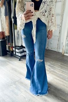 A pair of extreme flare jeans featuring a light distressed design, frayed raw hem, and ripped knee slits. These jeans offer two back patch pockets, faux front pockets, and a zip-fly closure.Rise: 11" Inseam: 34"Made In: Imported Fabric Contents: 73% Cotton, 14% Rayon, 11% Poly, 2% Spandex Ripped Cutoff Flare Jeans In Medium Wash, Flare Distressed Denim Jeans, Ripped Cutoff Medium Wash Flare Jeans, Distressed Cutoff Flare Jeans, Distressed Flare Denim Jeans, Medium Wash Ripped Cutoff Flare Jeans, Distressed Denim Flare Jeans With Cutoff, Distressed Denim Flare Jeans, Distressed Denim Cutoff Flare Jeans