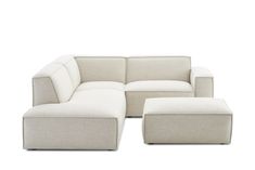 a white couch and ottoman sitting on top of a white floor next to each other