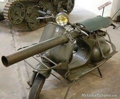 an old motorcycle with a tank attached to the back tire and side view mirror on it