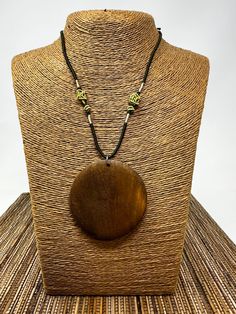 Brown Circle Pendant Necklace Experience the allure of nature and elegance. 🌳 Features:   - Natural Elegance: Flaunt a beautiful and natural wood design. Crafted with meticulous attention to detail, this pendant showcases the warm hues and rich patterns of genuine wood. - Versatility Unlocked: Unisex design makes it perfect for everyone, irrespective of gender. It's a piece that transcends style boundaries. - Optimal Size: Pendant measures a symmetrical 2.25" x 2.25", making it a statement with Nature-inspired Wooden Beaded Necklace As Gift, Natural Beaded Nature-inspired Jewelry, Bohemian Round Natural Necklaces, Handmade Ebony Necklaces For Gifts, Handmade Ebony Necklace For Gift, Adjustable Natural Wood Necklace Nature-inspired, Round Natural Color Necklace As Gift, Natural Round Necklace For Gift, Round Necklace In Natural Color For Gift