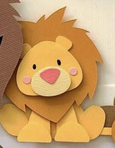 two paper cutouts of lions sitting next to each other