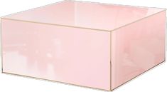 a pink square box with gold trim on the top and bottom, sitting in front of a white background