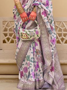 Make a grand entrance at weddings, festivals, and special occasions with our magnetic white floral printed silk festival wear saree with blouse. This stunning ensemble features a white silk saree with intricate floral print work and zari weaving, paired with a vibrant purple silk blouse adorned with matching print work and zari weaving. The 5.50-meter saree and unstitched blouse material allow for customization to ensure the perfect fit for any body type.
The vibrant white color exudes elegance White Silk Saree, Lehenga Crop Top, Floral Lehenga, Lehenga Choli Wedding, Party Wear Lehenga Choli, Reception Gown, Bollywood Lehenga, Cocktail Wear, Party Wear Lehenga