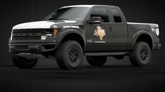 a black and white truck with an emblem on it's side, parked in a dark room