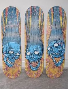 three skateboards with blue and orange designs on them