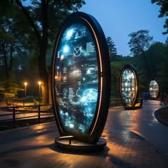 an outdoor display in the middle of a park at night with lights on it's sides