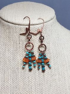 These boho chic turquoise bead and carnelian bead earrings feature top quality, natural stones.  The carnelian beads are hand carved melon shaped beads.  The turquoise are native to the Southwestern U. S. and are very tiny and round.  An antique copper chain sets off the triple drop.   These one-of-a-kind earrings were created by designer, Regie Roth Dangle Beaded Earrings With Gemstone Beads For Jewelry Making, Gemstone Beaded Dangle Earrings For Jewelry Making, Gemstone Beads Dangle Earrings For Jewelry Making, Adjustable Carnelian Earrings With Natural Stones, Bohemian Beaded Earrings With Natural Stones, Carnelian Dangle Earrings With Natural Stones, Carnelian Natural Stones Dangle Earrings, Artisan Beaded Dangle Earrings With Natural Stones, Artisan Natural Stone Beaded Dangle Earrings