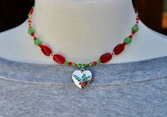 Christmas holly beaded red and green necklace/Christmas tree necklace/silver heart pendant with Christmas holly/handmade jewelry/Mom gift Handmade Jewelry For Holiday Gifts, Handmade Jewelry As Holiday Gift, Handmade Round Beads Jewelry For Holiday, Silver Beaded Necklace For Valentine's Day Gift, Silver Beaded Necklace With Heart Charm As Gift, Handmade Jewelry For Christmas Crafting, Silver Beaded Necklaces With Heart Beads For Gift, Silver Beaded Necklace With Heart Beads For Gift, Handmade Jewelry For Holiday Season