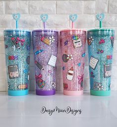 three different colored tumblers with designs on them, one is blue and the other has pink