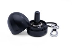 a black ring box with a pair of scissors on it and a keychain