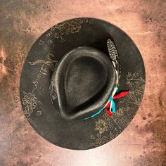 Rancher style cowboy hat for cowgirls custom burned by hand exclusively for Bourbon Cowgirl! We worked with this popular designer to create our very own look. 100% wool rancher hat in black which looks great with every outfit. One size fits all, as the interior band is adjustable to fit most. A beautiful rancher style with a pinch crease, this gorgeous black cowgirl hat is sanded and torched to a beautifully burnished and distressed finish. Firm shape (do not crush). Our artisan has hand burned Western Black Hat Band For Western-themed Events, Black Western Top Hat For Rodeo, Western Black Felt Hat For Ranch, Western Black Felt Hat For Western-themed Events, Western Style Black Top Hat For Western-themed Events, Western Black Fedora For Western-themed Events, Black Felt Hat With Flat Crown For Ranch, Black Western Fedora For Western-themed Events, Western Style Black Fedora For Western-themed Events