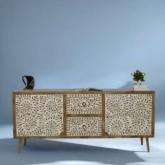 a white and brown sideboard with two drawers on one side and an open drawer on the other