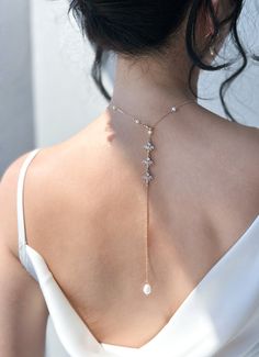 This romantic drop back chain is perfect for your backless bridal gown or evening dresses. Made from fresh water pearl and shinny zirconia charms. You can either choose a multiple pearl or single pearl choker style.  Matching earrings & bracelet: https://nikyglam.etsy.com/listing/1506173529 ♥Lead and nickel free ♥Made from shinny and high-quality cubic zirconia crystal  ♥Custom design and length possible ♥Handmade with love ♡JEWELRY DETAILS♡ 【Chain】 Length around neck: 40 - 45 cm / select length Elegant Cubic Zirconia Backdrop Necklace With Delicate Chain, Crystal Clavicle Chain Backdrop Necklace For Wedding, Crystal Backdrop Necklace With Clavicle Chain For Wedding, Elegant Crystal Bridal Necklace With Adjustable Chain, Elegant Teardrop Backdrop Necklace With Adjustable Fit, Crystal Lariat Necklace With Adjustable Chain For Wedding, Wedding Crystal Necklace With Adjustable Chain, Elegant Pearl Charm Drop Necklace For Wedding, Elegant Cubic Zirconia Lariat Necklace For Wedding