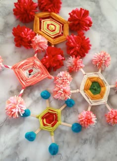 some colorful paper flowers on top of a marble table