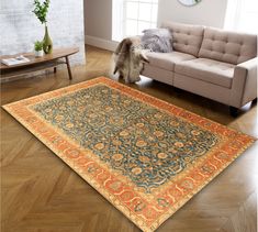 a living room with a couch and rug on the floor