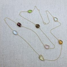 Semi-precious stone with 18k Solid Gold Necklace Stone: Semi-Precious Stone (Citrine, Blue Topaz, Rose Quartz, Lemon Quartz, Garnet, Green Amethyst, Peridot, Smokey Quartz)           -Shape: Free Form           -Cut: Double-Sided Cabochon           -Color: Orange, Blue, Pink, Yellow, Red, Light Green, Brown, Green           -Weight: ~26ct           -Quantity:  8 pieces           -Quality: Please refer to the picture, only 1 piece is available Necklace Length: 81cm (32in) The stones were bezel-se Yellow Gold Gemstones For Anniversary, Yellow Gold Round Jewelry With Stones, Yellow Multi-stone Round Gemstones, Gold Gemstones With Round Gemstone Accents, Gold Multi-stone Fine Jewelry Gemstones, Gold Multi-stone Gemstones In Fine Jewelry Style, Anniversary Jewelry With 17 Jewels And Citrine, Gold Oval Multi-stone Jewelry, Yellow Gold Citrine Gemstones For Gift