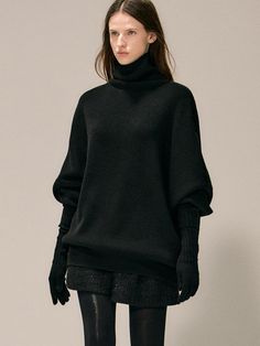 This luxurious oversized turtleneck sweater combines comfort and style with its 15% wool blend composition and relaxed drop-shoulder silhouette. The versatile piece features a hip-covering length that allows it to be styled as both a sweater or mini dress, making it a perfect transitional wardrobe staple. Its sophisticated design works equally well as a standalone statement piece or layered under outerwear, while the turned-up turtleneck adds an elegant finishing touch to this contemporary knitw Chic Winter Turtleneck With Ribbed Cuffs, Chic Chunky Knit Winter Turtleneck, Chic Chunky Knit Turtleneck For Winter, Oversized Turtleneck For Winter Layering, Oversized Turtleneck For Workwear In Fall, Oversized Turtleneck For Fall Workwear, Elegant Soft Knit Winter Turtleneck, Elegant Soft Knit Turtleneck For Winter, Oversized Soft Knit Turtleneck For Winter