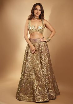 Introducing the Lampi lehenga set, a stunning ensemble that embodies timeless elegance and contemporary charm. The lehenga features intricate mirror work, meticulously handcrafted to accentuate its rich texture and vibrant hues. Paired with a matching mirror-embellished blouse and complemented by a mirror dupatta, this ensemble exudes grace and sophistication, perfect for any special occasion or celebration. Festive Gold Pre-draped Saree With Sequins, Gold Pre-draped Saree For Reception And Festive Occasions, Glamorous Saree With Resham Embroidery For Navratri, Gold Art Silk Palazzo Set For Festivals, Glamorous Floor-length Sharara With Resham Embroidery, Gold Art Silk Palazzo Set For Diwali, Gold Pre-draped Saree For Navratri Party, Glamorous Resham Embroidery Saree For Navratri, Diwali Gold Art Silk Palazzo Set