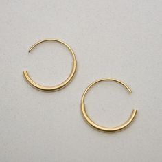 "A timeless classy earrings for a modern style, you can truly wear these gold medium everyday hoops with any outfit and they will look beautiful. Designed from a combination of a half hoop of 2mm soldered to a thiner half hoop of 1mm going through the lobe. Handmade by 22K yellow gold fill over sterling silver (5 micrometers of gold) also available in sterling silver, both matte finished. Hoops measure 22mm in diameter. Post of 19 gauge wire // 1mm diameter This listing is for one pair of earrin Simple Hoop Huggie Earrings For Everyday, Simple Small Hoop Yellow Gold Earrings, Simple Small Hoop Earrings In Yellow Gold, Simple Small Yellow Gold Hoop Earrings, Minimalist Everyday Brass Huggie Earrings, Chic Brass Hoop Earrings For Everyday, Minimalist Simple Hoop Earrings For Everyday, Trendy Yellow Gold Brass Hoop Earrings, Everyday Minimalist Brass Huggie Earrings