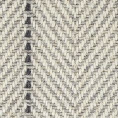 an up close shot of the fabric on a white and black sweater with grey stripes