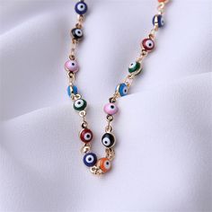 Bring colorful shine to your look with this necklace showcasing multi-hued Evil Eye beads. 13.39'' L with 1.97'' extender Lobster claw clasp Goldtone copper / enamel Colorful Jewelry With Adjustable Chain, Multicolor Metal Necklace With Adjustable Chain, Colorful Necklace With Adjustable Chain As Gift, Multicolor Round Jewelry With Lobster Clasp, Multicolor Enamel Jewelry With Lobster Clasp, Trendy Multicolor Evil Eye Jewelry, Multicolor Jewelry With Dangle Adjustable Chain, Multicolor Dangle Jewelry With Lobster Clasp, Adjustable Multicolor Metal Chain Necklace