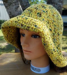 This hat is stylish sun protection and is machine washable. Dress it up with a scarf or flower. Cotton Sun Hat, One Size Wide Brim Crochet Hat For Warm Weather, Yellow Yarn Crochet Hat, Knitted Wide Brim Sun Hat For Vacation, Knitted Wide Brim Sun Hat, Brimmed Knitted Sun Hat For Vacation, Brimmed Knitted Sun Hat For The Beach, Knitted Brimmed Sun Hat For Beach, Knitted Sun Hat For The Beach