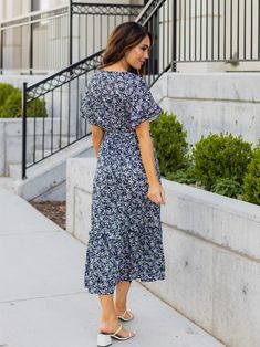 Looking for a dress that will make you stand out in a crowd? Look no further than the Floral Pattern Whitney Dress in mint floral! This dress is all about fun and flirty style, with a colorful floral print that's sure to turn heads. But it's not just about looks - this dress is designed to flatter your curves, with a tie waist that accentuates your figure. And with flutter sleeves and a midi length, it's the perfect combination of playful and sophisticated. Whether you're headed to a wedding, a Flowy Floral Print Dress For Casual Occasions, Chic Blue Printed Floral Dress, Blue Floral Short Sleeve Dress For Garden Party, Blue Floral Print Short Sleeve Dress, Blue Floral Print Dress For Day Out, Flowy Ditsy Floral Dress For Garden Party, Blue Floral Sundress For Day Out, Blue Floral Sundress For Garden Party, Casual Flowy Ditsy Floral Dress