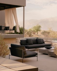 a black couch sitting on top of a patio