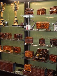 shelves filled with lots of different types of items in glass cases next to each other