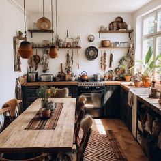 a kitchen with lots of pots and pans hanging from the wall above the stove