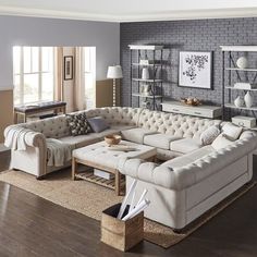 a living room filled with furniture and a brick wall behind the couch is a coffee table