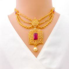 Crafted with exquisite attention to detail, this 22k yellow gold set weighs 54.8 grams and features a royal vintage design. It is adorned with uncut diamonds (Polki), totaling 11.18 carats, and further embellished with rubies and pearls, collectively weighing 34.2 carats. The set has a length of 16 inches, with an impressive drop length of 2.2 inches, and is secured with a hook lock and adjustable links for tailored comfort. The matching earrings, at a length of 2.1 inches, complete the set, eac Gold Chandbali Bridal Necklace With 17 Jewels, Gold Plated Temple Jewelry Bridal Necklace For Reception, Gold Temple Necklace With Stone Work For Ceremonial Use, Ceremonial Gold Temple Necklace With Stone Work, Gold Ruby Jewelry With Filigree Detail, Luxury Gold Necklace With Stone Work, Luxury Gold Chandbali Necklace, Festive Gold Kundan Necklace With Ruby, Gold 22k Pearl Necklace For Wedding