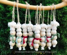 several snowman ornaments hanging from a tree