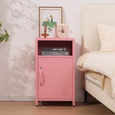 a pink locker next to a bed in a bedroom