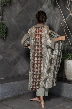 This unique, beautiful robe for women is made from a super soft rayon fabric. It is printed with a multicolor original Oriki print incorporating warm grey tones with patterns of blacks and reds. It is the ideal boho style kimono robe for women who want something different without sacrificing comfort. This robe has long sleeves, plain colored borders and falls at about mid-calf length. My designs feature my original graphics and illustrations. I love working with different color palettes and desi Bohemian Sets With Kimono Sleeves For Festive Occasions, Bohemian Sets With Multicolor Kimono Sleeves, Bohemian Festive Sets With Kimono Sleeves, Bohemian Tunic Sets With Printed Motifs, Festive Bohemian Sets With Kimono Sleeves, Bohemian Sets With Printed Motifs Tunic, Bohemian Sets With Printed Motifs And Tunic Shape, Bohemian Printed Tunic Set, Bohemian Eid Tunic With Printed Motifs