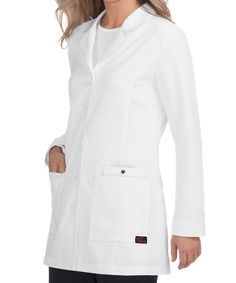 The Betsey Johnson B400 Marigold Women's Lab Coat features a button front with 5 buttons and a rounded collar. For storage, it has 2 patch pockets and an additional inner pocket on the left with a metal heart snap. There is printed facing in the back of the neck and bottom of cuffs for accent. The back vent and princess seams with sewn on back belt detail allow for a better fit. Its easy care stretch fabric is made up of 77/20/3 poly/rayon/spandex stretch twill. Doctor White Coat, Women's Lab Coat, Heart Snap, Fun Scrubs, Uniform Advantage, Lab Coats, Professional Wardrobe, Metal Heart, Notch Collar