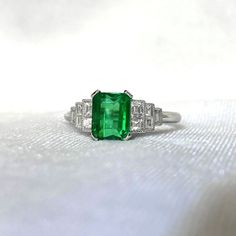 ** This item has just been reserved by another customer. Please contact us to be notified if it becomes available.  An elegant 1.28-carat emerald at the center of this gemstone ring is set in four prongs. Five baguette-cut diamonds frame the center stone in a graduated pattern on each shoulder. This ring has a total of 0.37 carats of diamonds. Platinum was used to make this ring by hand. ✦STONE SPECIFICATIONS: Center Emerald Size: Approx 1.28 Carats Total Diamond Weight: Approx 0.37 Carats Cente Estate Diamond Jewelry, Rare Jewelry, Halo Diamond Earrings, Emerald Cut Engagement, Halo Earrings, Emerald Engagement Ring Cut, Baguette Cut Diamond, Engagement Ring Cuts, Emerald Gemstone