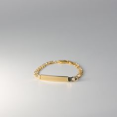 Introducing our elegant Real 14K Gold ID Bracelet with Figaro Link, a perfect fusion of modern style and timeless sophistication. Meticulously crafted, this bracelet is not just a piece of jewelry; it's a symbol of personal identity and enduring elegance. Your Unique Statement: Our Gold ID Bracelet offers a personalized touch with an engraved ID tag, allowing you to carry a name or message that holds special meaning to you. The Figaro Link design adds a contemporary flair to this classic piece. Cool Piercings, Id Bracelets, Bar Bracelets, Heartfelt Gifts, Chain Link Bracelet, Chain Link, Arm Band, Personalized Jewelry, Thoughtful Gifts