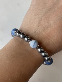 8mm round shaped, polished magnetic silver colored beads with 10mm beautiful light blue agate stone beads with the strongest 7mm magnetic clasp on the market. This bracelet is BEAUTIFUL  Every agate stone is unique.  Relieve wrist or finger inflammation pain safely and naturally!  For most people I would recommend a minimum size of 7" for this size bead. This bead would require you adding at least 1/2" more than your wrist size.  Magnetic Therapy works by creating a magnetic field that penetrate Silver Crystal Bracelet With Agate Gemstone Beads, Silver Agate Crystal Bracelet With Gemstone Beads, Silver Agate Gemstone Beads Crystal Bracelet, Silver Agate Crystal Bracelet With Round Beads, Silver Agate Stretch Bracelet Gift, Silver Bracelets With Agate Round Beads, Silver Agate Bracelets With Round Beads, Adjustable Magnetic Jewelry With Round Beads, Silver Magnetic Beaded Bracelets With Round Beads