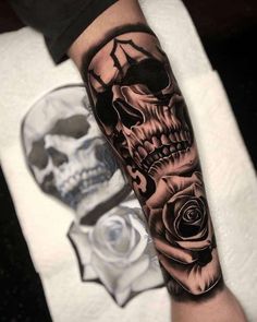 a man with a skull and rose tattoo on his arm