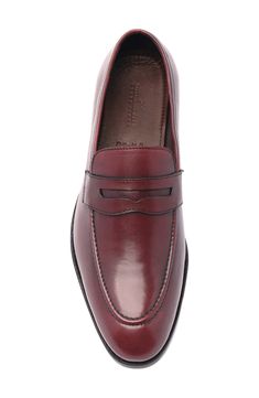 A classic penny keeper and an apron toe lend timeless sophistication to a leather loafer that will elevate your polished style. Leather upper and lining/rubber sole Imported Asian Owned/Founded Official Wear, Penny Loafers Men, Polished Style, An Apron, Penny Loafer, Red Burgundy, Penny Loafers, Burgundy Red, Leather Loafers