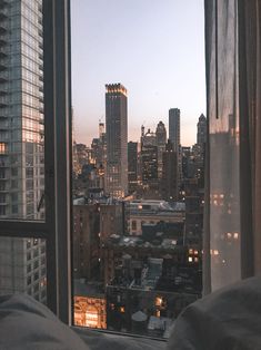 a view of the city from a bedroom window