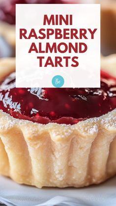 mini raspberry almond tarts on a plate with a sign over the top