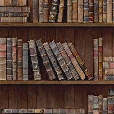 an old book shelf filled with lots of books on top of wooden shelves next to each other