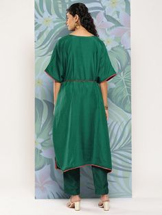 Green embroidered Kurta with TrousersKurta design:Solid with placement embroideryKaftan shapeRegular styleV-neck, three-quarter extended sleevesZari detailCalf length length with flared hemCotton blend machine weave fabricComes with a fabric beltTrousers design:Solid TrousersPartially elasticated waistbandSlip-on closure Green Embroidered Cotton Kaftan, Semi-stitched Green Embroidered Kurta, Green Embroidered V-neck Kurta, Embroidered Hem Tunic Kurta, Embroidered Cotton V-neck Kaftan, Fabric Belt, Kurta Designs, Thread Work, Yellow Floral