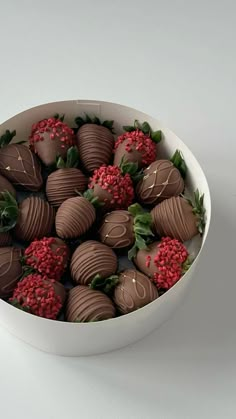 a white bowl filled with chocolate covered strawberries